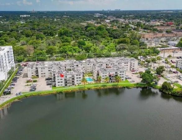 an aerial view of residential houses with outdoor space and swimming pool