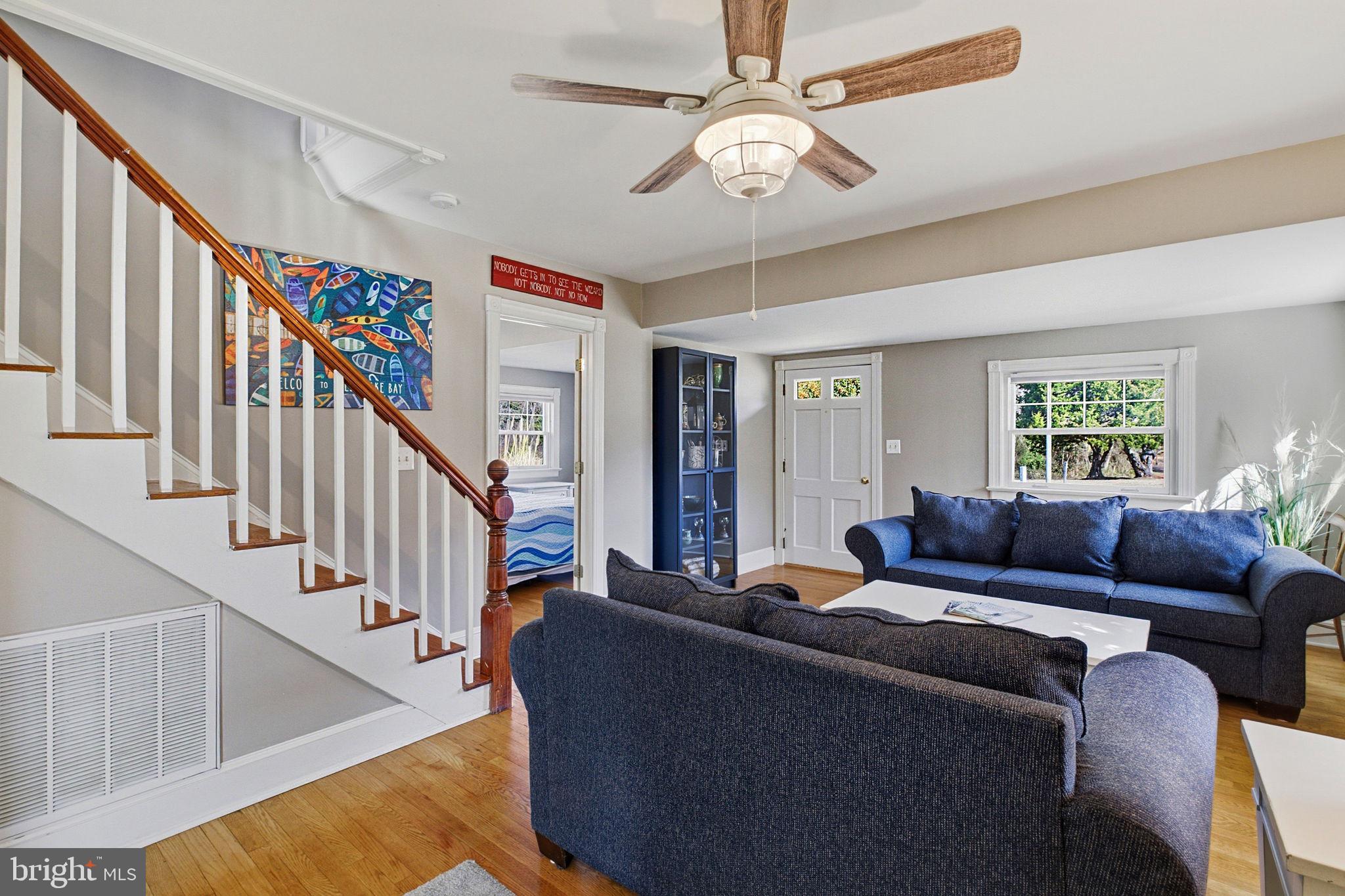 519 Whitehall Road Lancaster, VA 22503 - Photo 15 of 46 a living room with furniture ceiling fan and a window