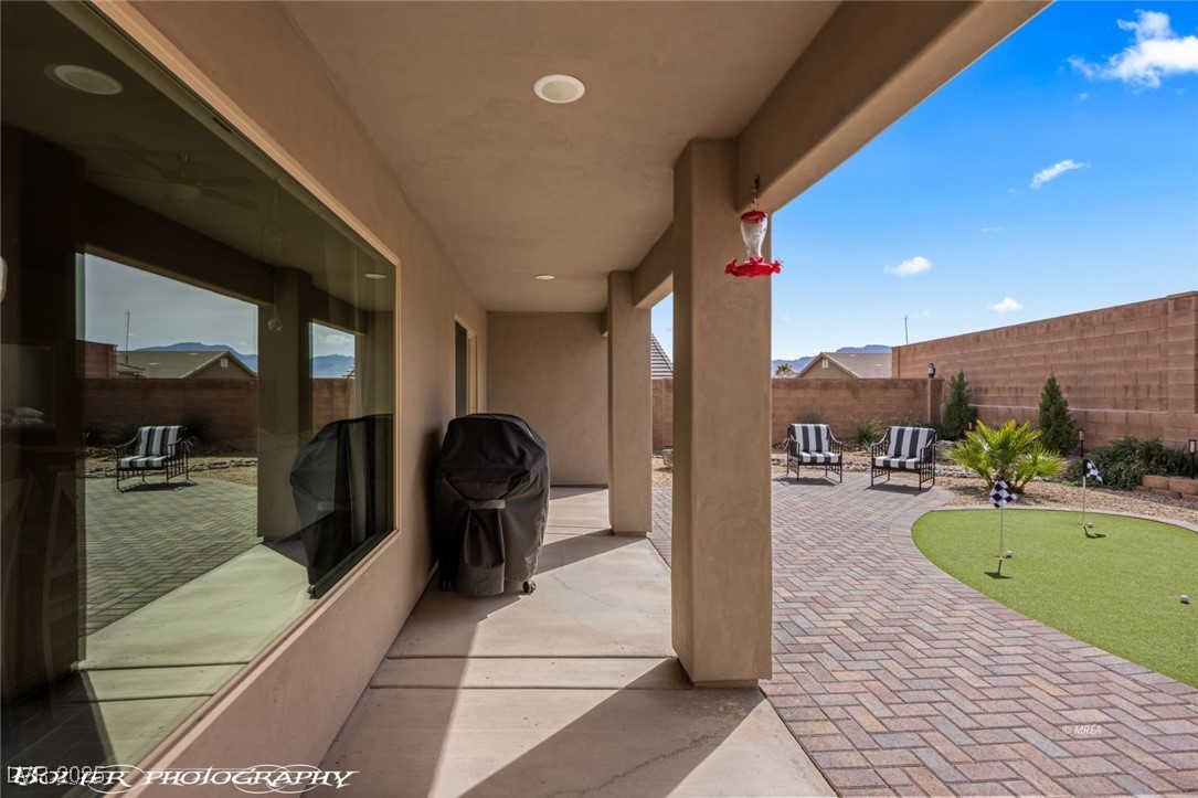 942 Shadow Hawk Ridge Mesquite, NV 89027 - Photo 47 of 67 View of patio / terrace featuring a putting green and a fenced backyard