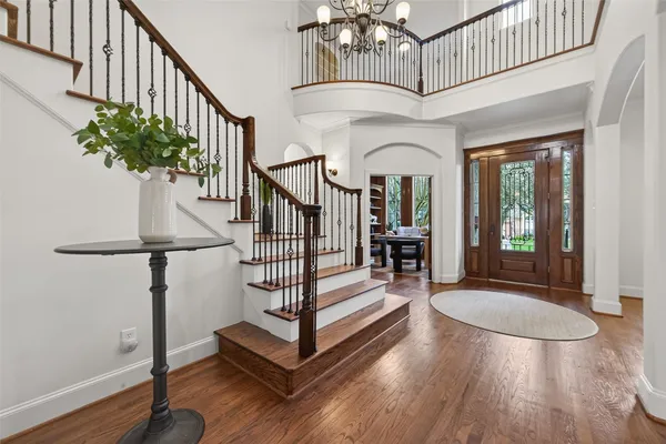 a living room with hard wood floors and furniture