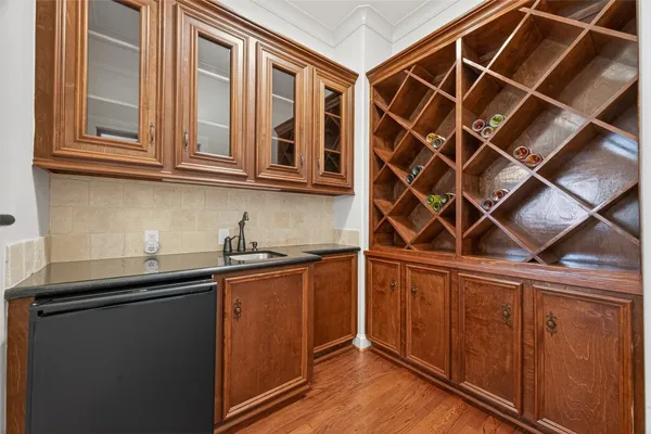 an empty room with wooden floor and mirror