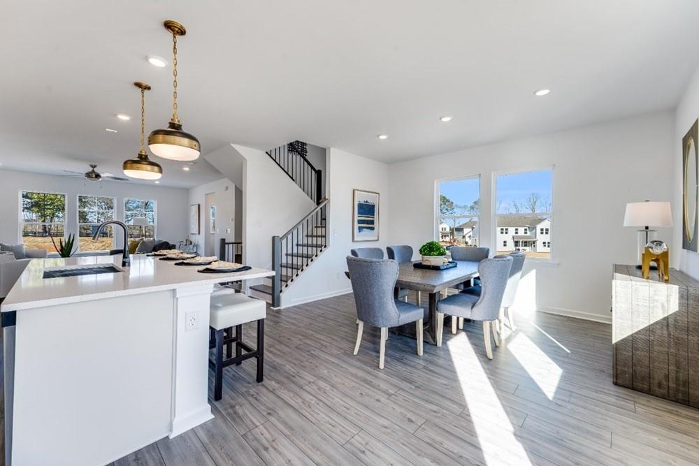 3195 Eastham Run Drive Dacula, GA 30019 - Photo 13 of 35 a view of a dining room with furniture and wooden floor