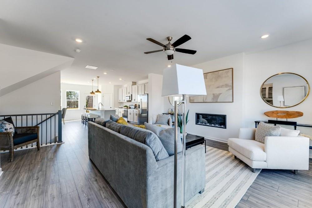 3195 Eastham Run Drive Dacula, GA 30019 - Photo 21 of 35 a living room with furniture a fireplace and wooden floor