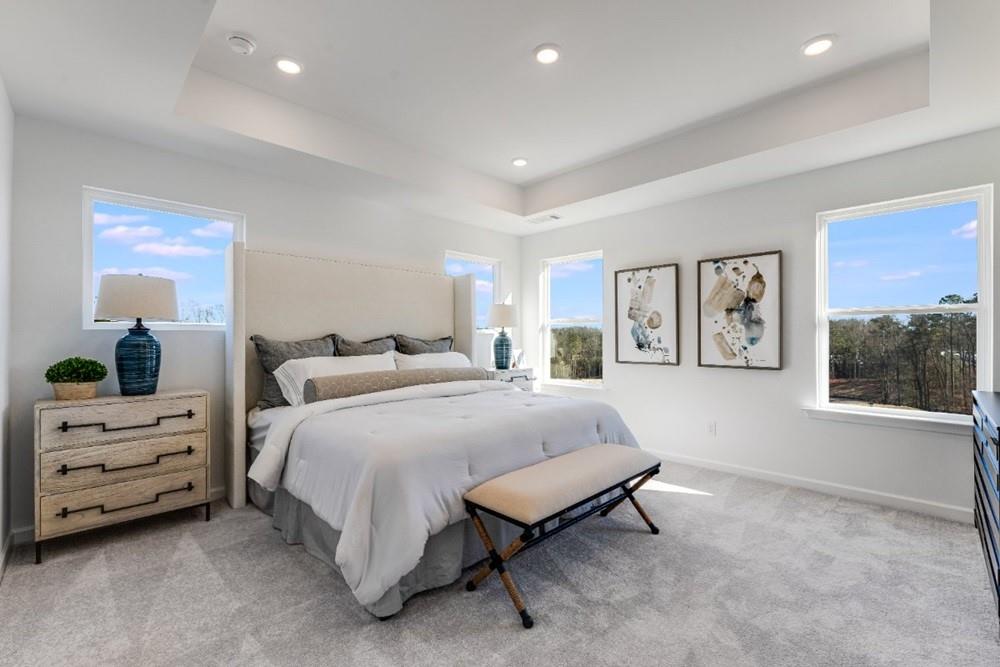 3195 Eastham Run Drive Dacula, GA 30019 - Photo 25 of 35 a spacious bedroom with a bed and a couch