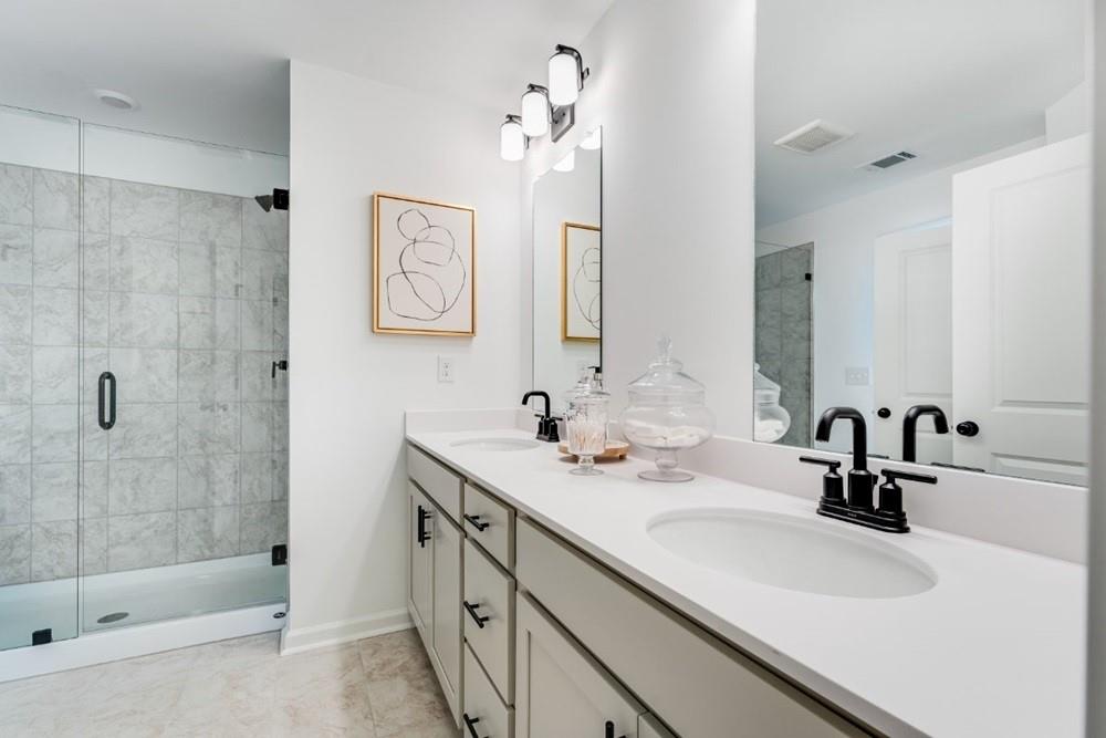 3195 Eastham Run Drive Dacula, GA 30019 - Photo 29 of 35 a bathroom with a sink double vanity and shower