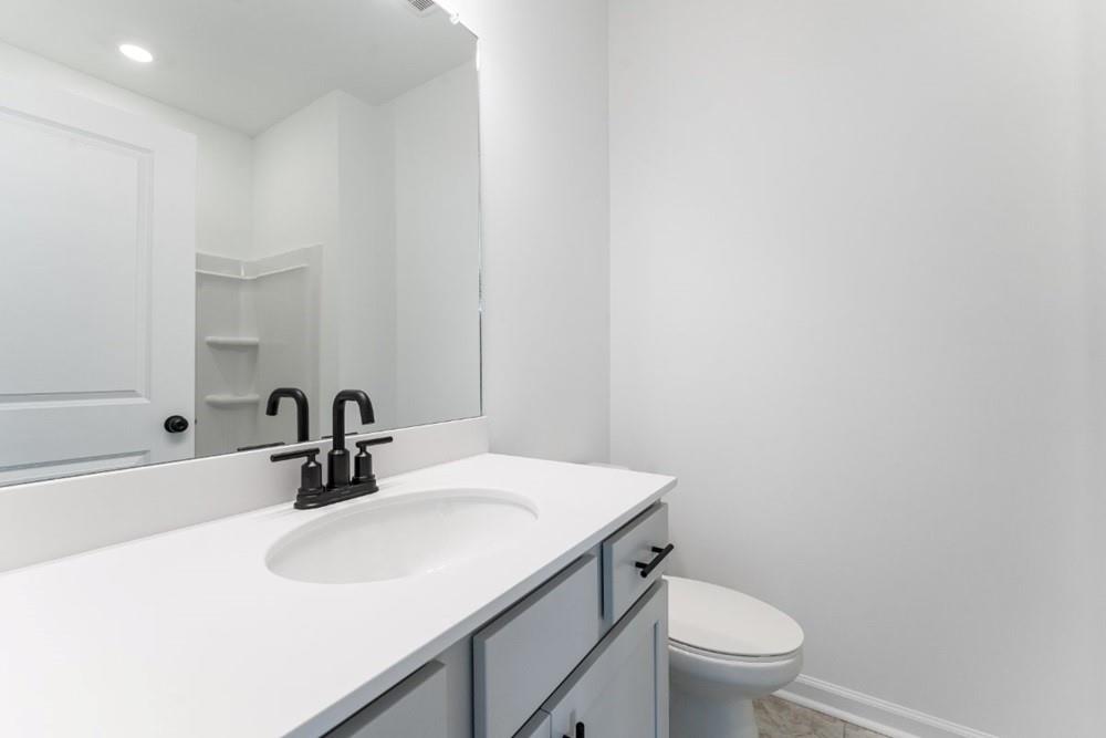 3195 Eastham Run Drive Dacula, GA 30019 - Photo 9 of 35 a bathroom with a sink toilet and a mirror