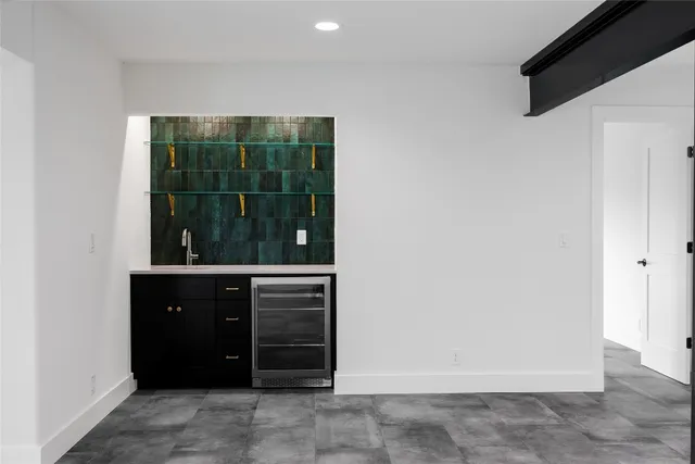 a room with a large window and cabinets