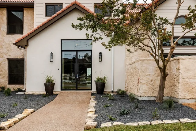 a front view of a house with garden