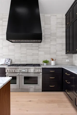 a kitchen with stainless steel appliances a stove and a microwave