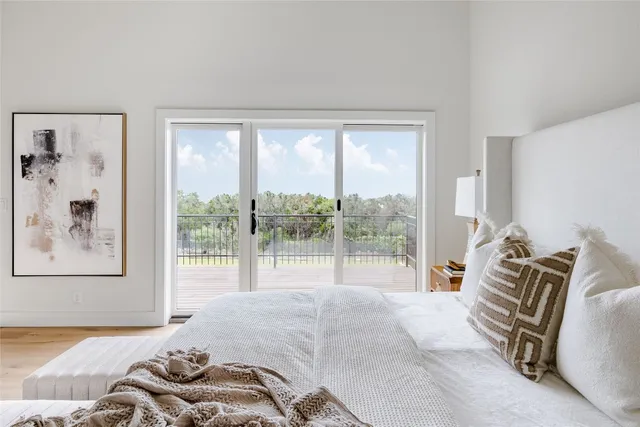 a bedroom with furniture and a large window