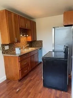 a kitchen with stainless steel appliances granite countertop a sink stove and cabinets