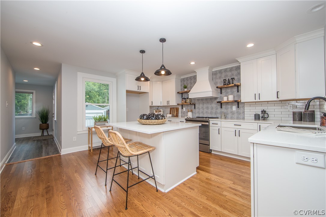4213 Brook Road Richmond, VA 23227 - Photo 12 of 49 a kitchen with stainless steel appliances a dining table chairs stove and cabinets