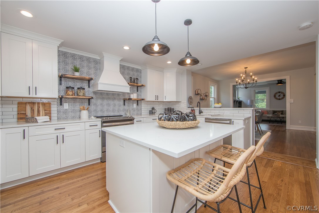 4213 Brook Road Richmond, VA 23227 - Photo 14 of 49 a kitchen with stainless steel appliances kitchen island granite countertop a sink a stove a dining table and chairs