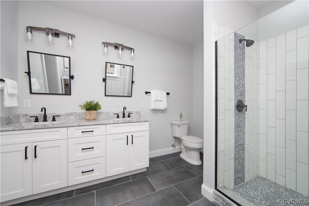 4213 Brook Road Richmond, VA 23227 - Photo 25 of 49 a bathroom with a granite countertop toilet sink and mirror
