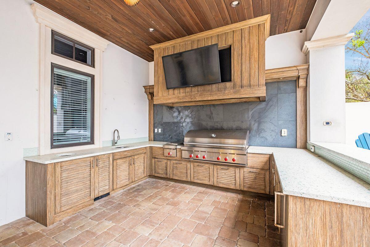 55 Sunfish Street Destin, FL 32541 - Photo 18 of 49 a kitchen with stainless steel appliances granite countertop a stove and a microwave