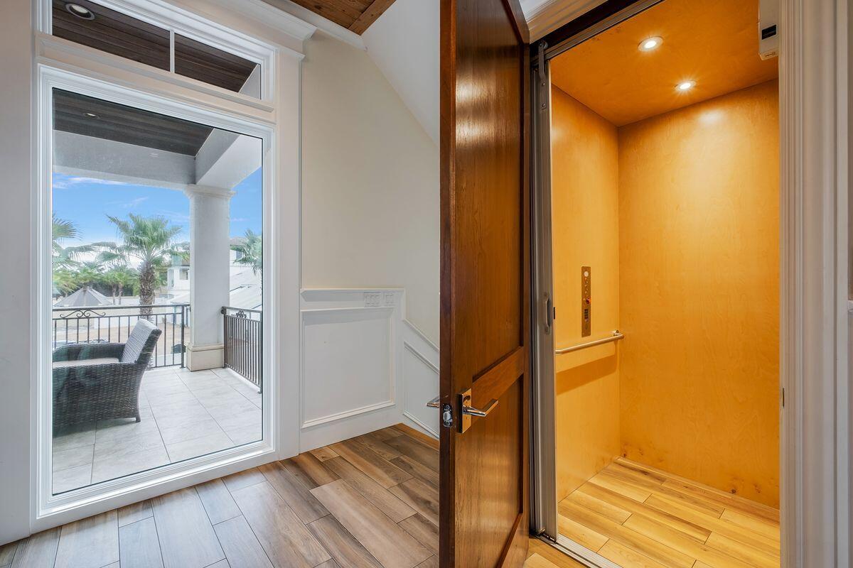 55 Sunfish Street Destin, FL 32541 - Photo 21 of 49 a view of a hallway with wooden floor and a living room