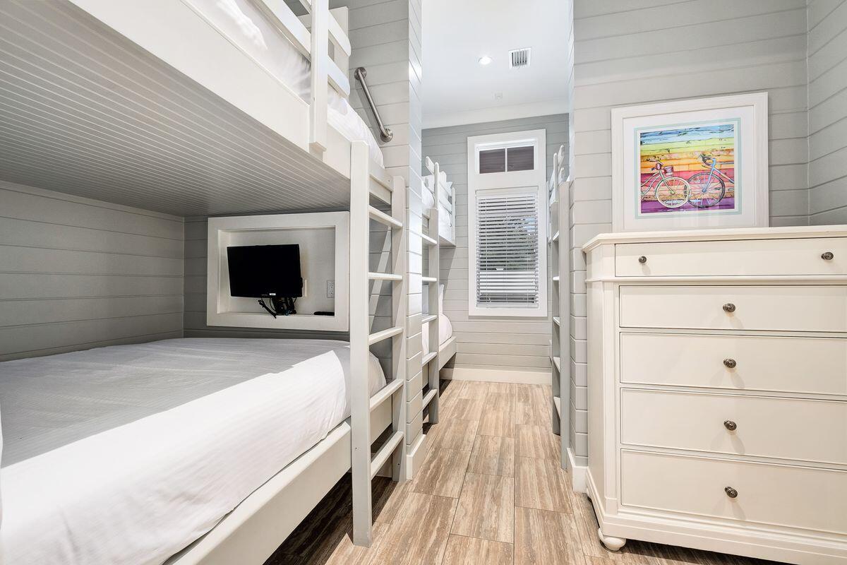 55 Sunfish Street Destin, FL 32541 - Photo 22 of 49 a view of a bedroom with wooden floor and windows