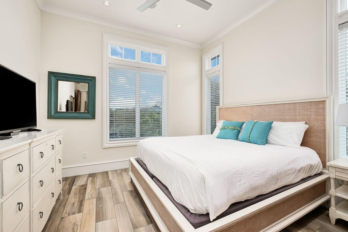55 Sunfish Street Destin, FL 32541 - Photo 25 of 49 a bedroom with a large bed and a flat tv screen on dresser