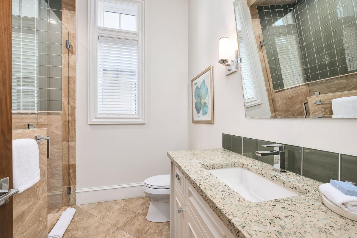 55 Sunfish Street Destin, FL 32541 - Photo 28 of 49 a bathroom with a granite countertop sink a toilet a mirror and shower