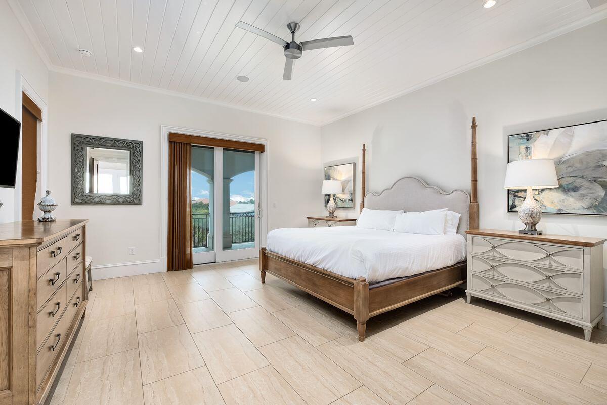 55 Sunfish Street Destin, FL 32541 - Photo 30 of 49 a bedroom with a large bed a chandelier and dresser
