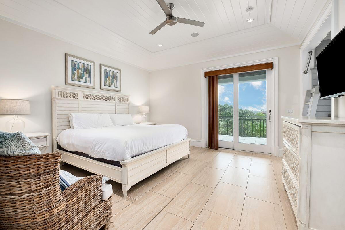 55 Sunfish Street Destin, FL 32541 - Photo 34 of 49 a bedroom with a bed wooden floor and flat screen tv