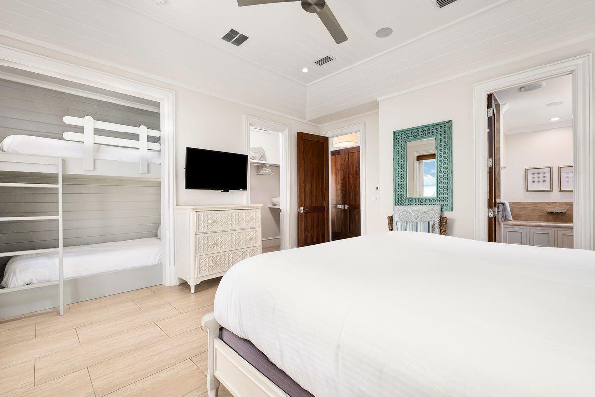 55 Sunfish Street Destin, FL 32541 - Photo 35 of 49 a spacious bedroom with a bed and a flat screen tv