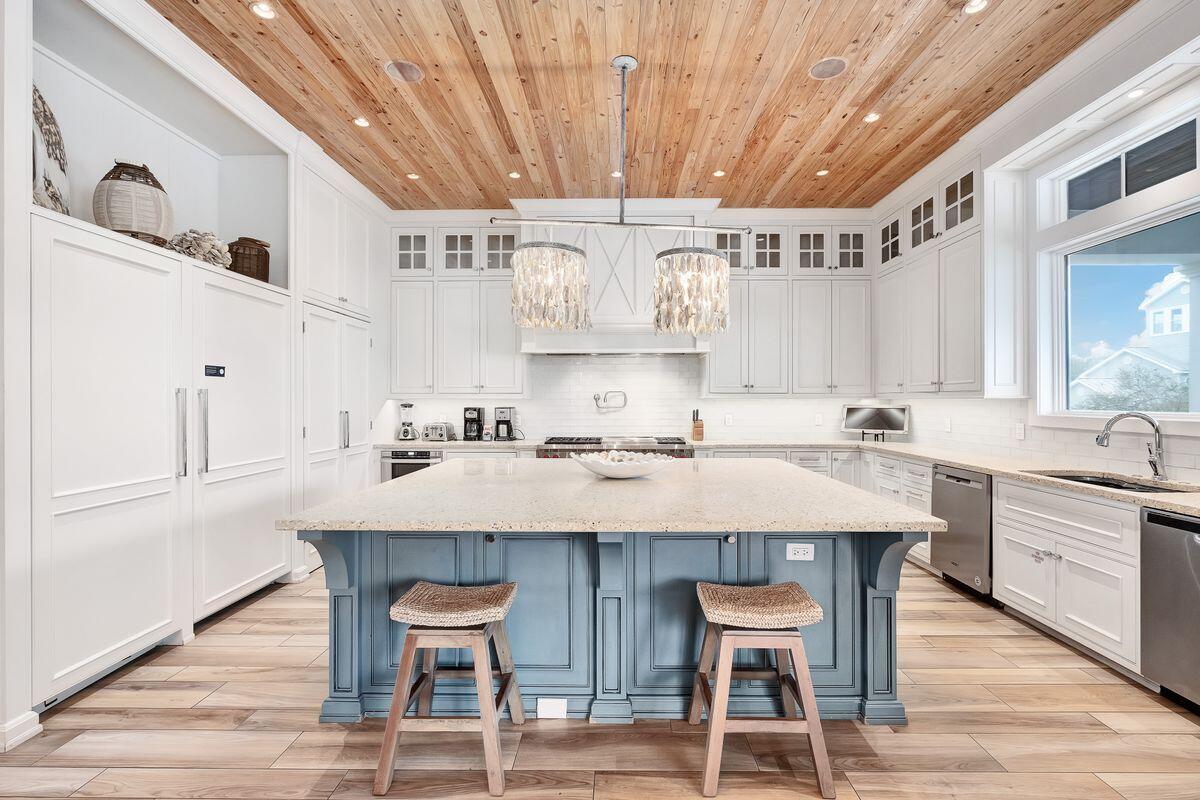 55 Sunfish Street Destin, FL 32541 - Photo 5 of 49 a kitchen with stainless steel appliances granite countertop a table chairs sink and cabinets