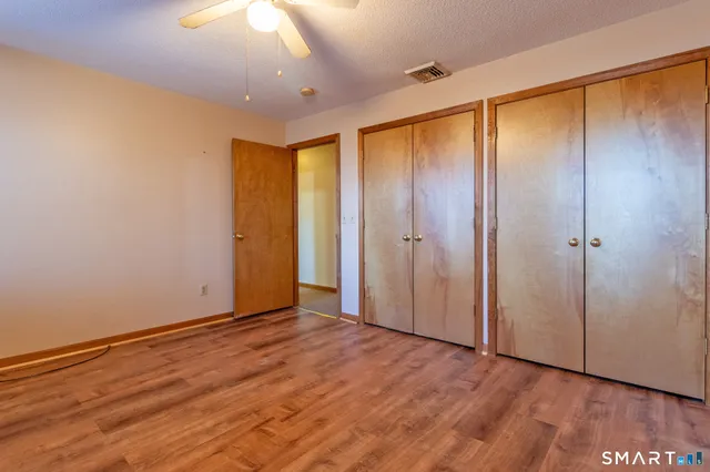 an empty room with wooden floor and closet