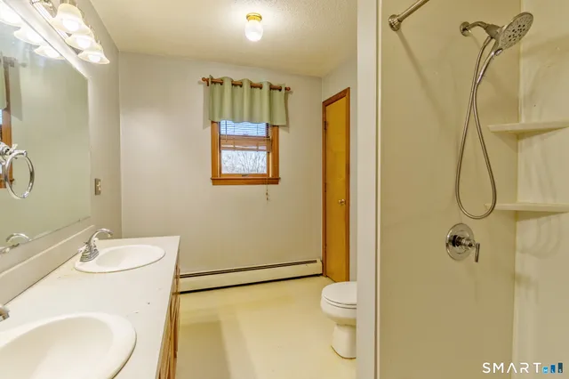 a bathroom with a sink toilet and shower