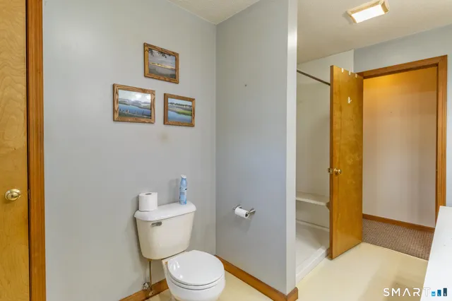 a white toilet sitting next to a bathroom sink