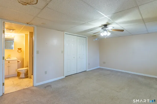 wooden floor in an empty room and a bathroom
