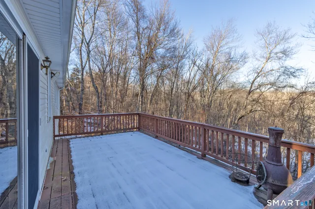 a view of balcony with wooden floor and fence