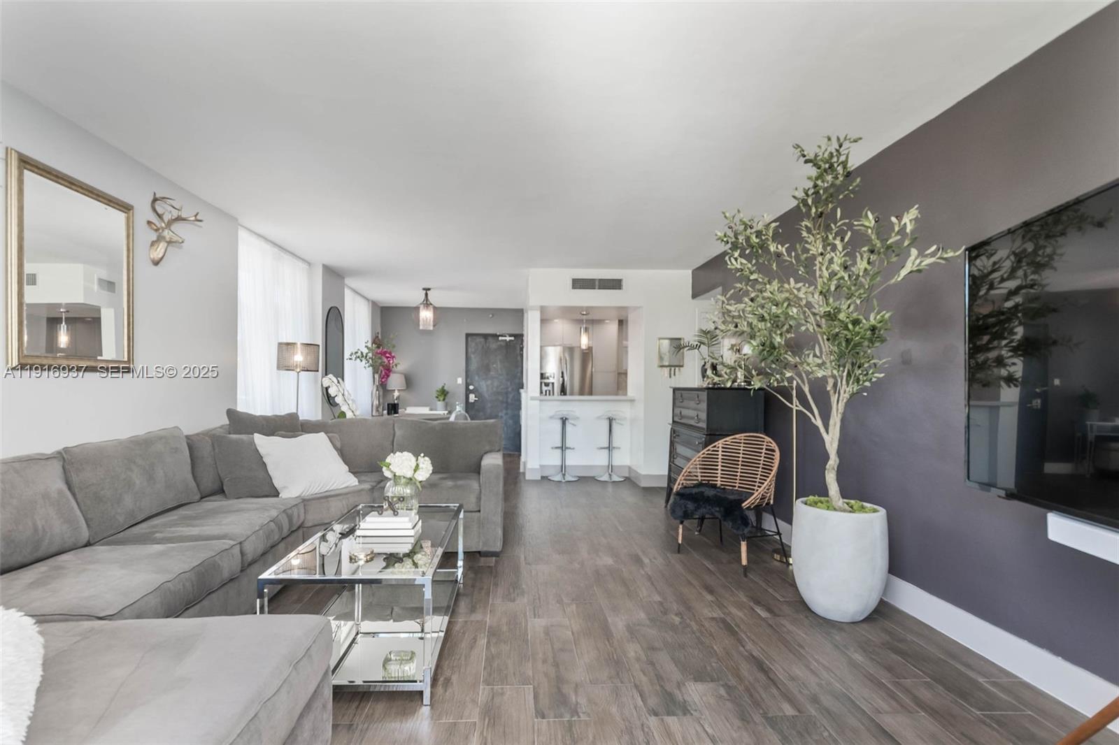 1200 West Avenue, Unit 316 Miami Beach, FL 33139 - Photo 11 of 44 a living room with furniture a chandelier and a couch