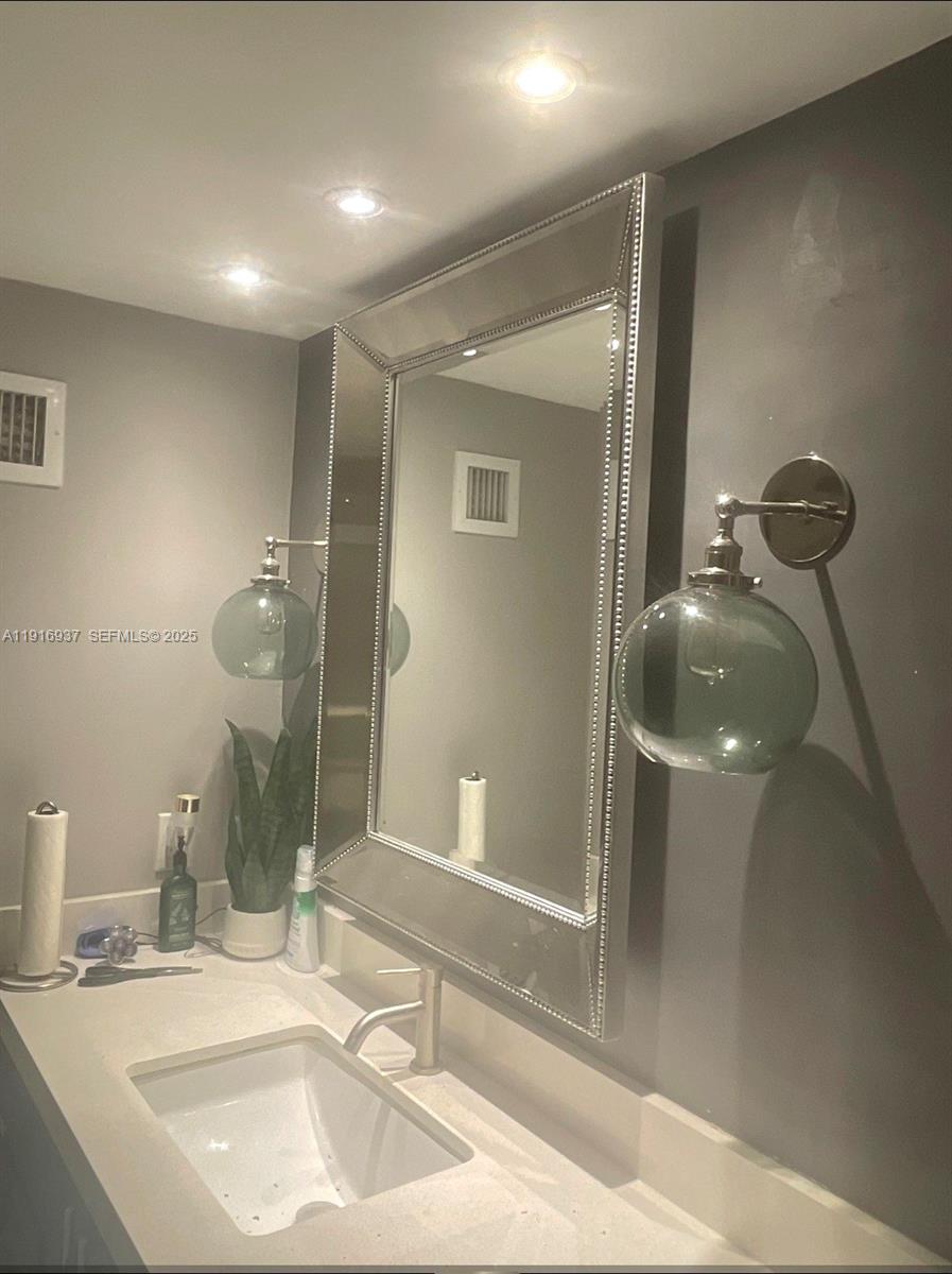 1200 West Avenue, Unit 316 Miami Beach, FL 33139 - Photo 20 of 44 a bathroom with a sink and a mirror