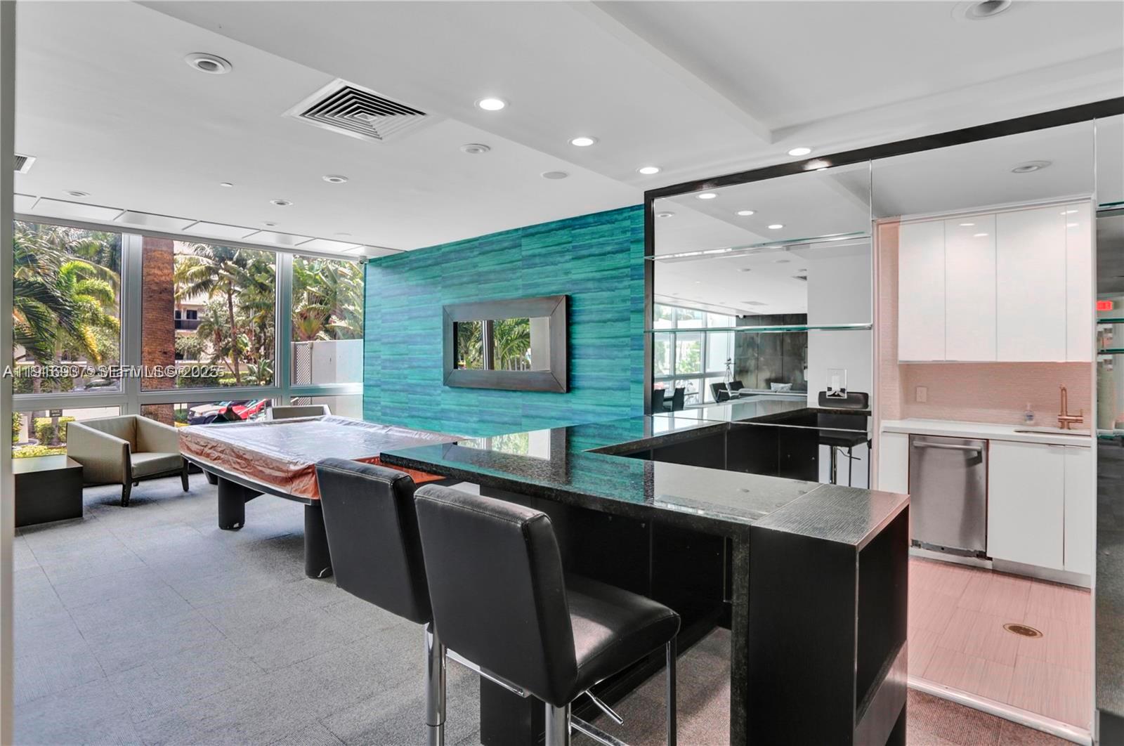 1200 West Avenue, Unit 316 Miami Beach, FL 33139 - Photo 31 of 44 a dining hall with stainless steel appliances kitchen island granite countertop a dining table and chairs