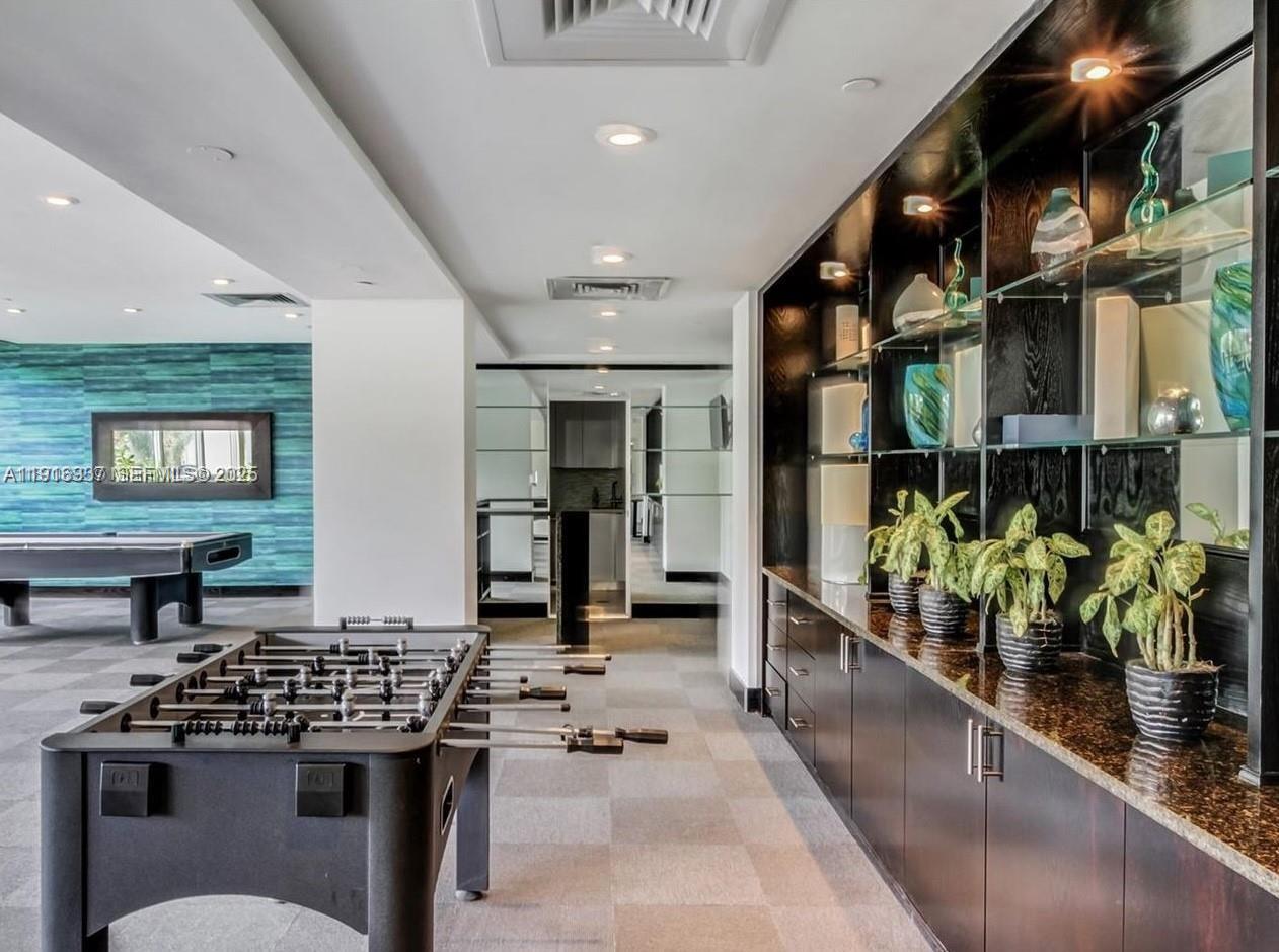 1200 West Avenue, Unit 316 Miami Beach, FL 33139 - Photo 32 of 44 a kitchen with stainless steel appliances kitchen island granite countertop a stove a sink and a dining table