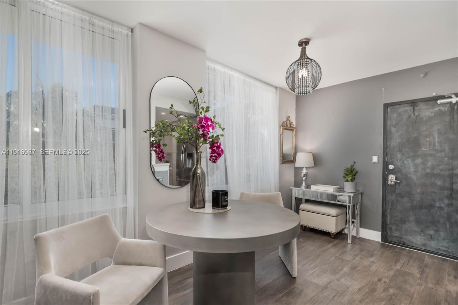 1200 West Avenue, Unit 316 Miami Beach, FL 33139 - Photo 4 of 44 a view of a dining room with furniture and chandelier