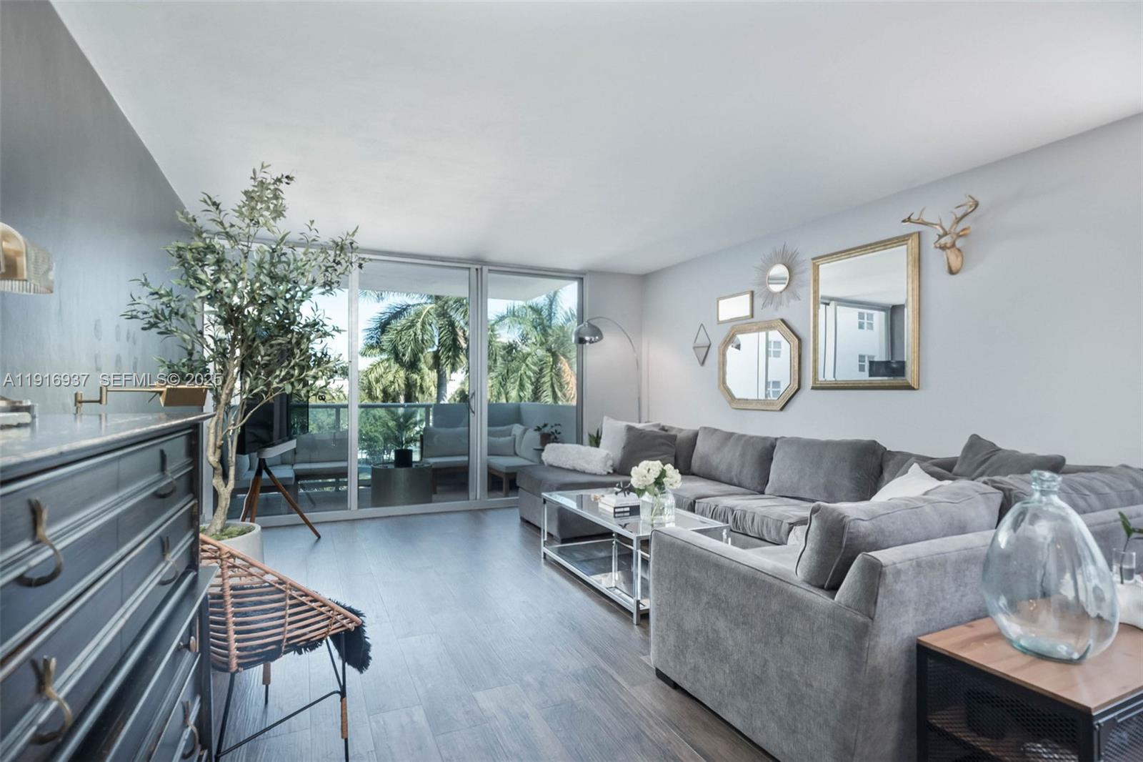 1200 West Avenue, Unit 316 Miami Beach, FL 33139 - Photo 10 of 44 a living room with furniture and a potted plant