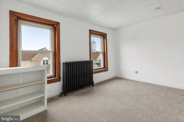 a view of an empty room and a window