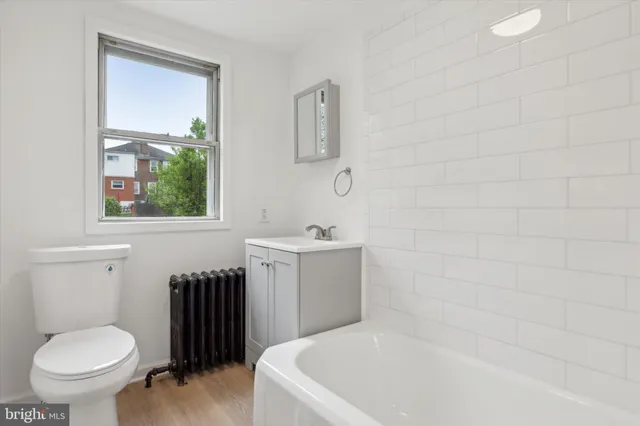 a bathroom with a sink a toilet and mirror