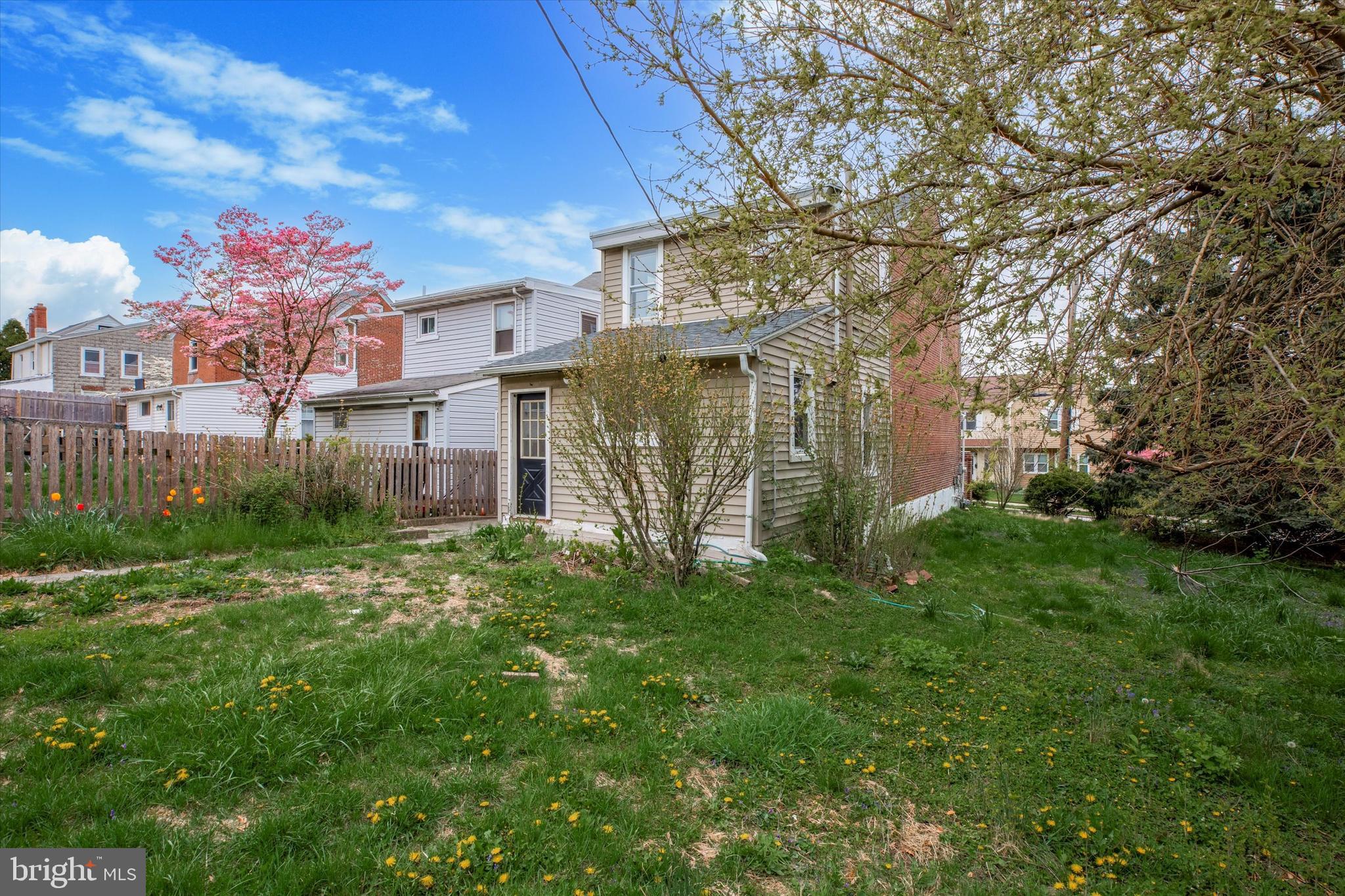 823 Coates Street Bridgeport, PA 19405 - Photo 20 of 20 a brick building with a big yard plants and large trees