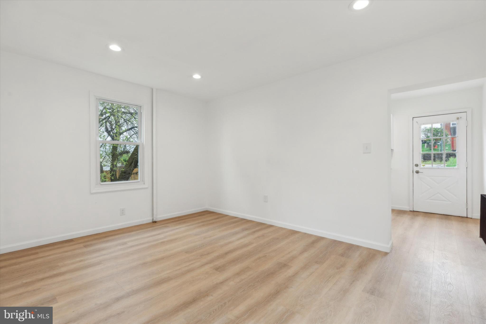 823 Coates Street Bridgeport, PA 19405 - Photo 5 of 20 a view of an empty room with wooden floor and a window
