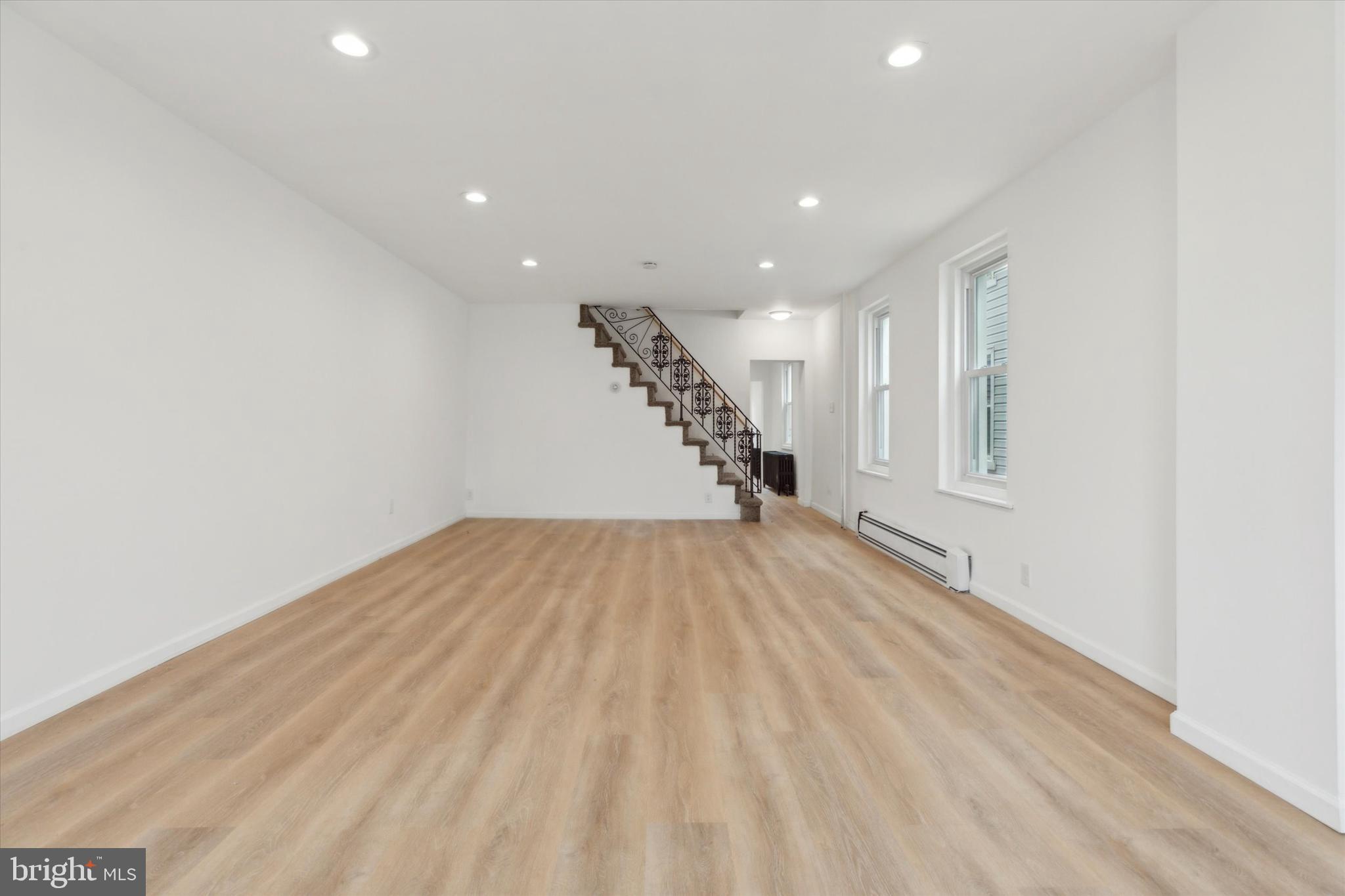 823 Coates Street Bridgeport, PA 19405 - Photo 7 of 20 a view of empty room with wooden floor and fan