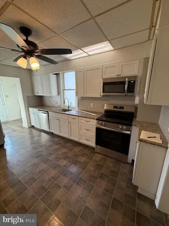 a kitchen with stainless steel appliances granite countertop a stove sink and microwave