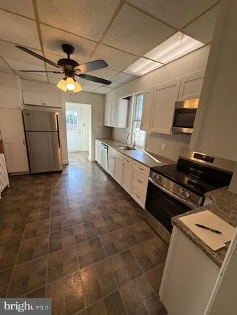 a kitchen with a stove and a refrigerator