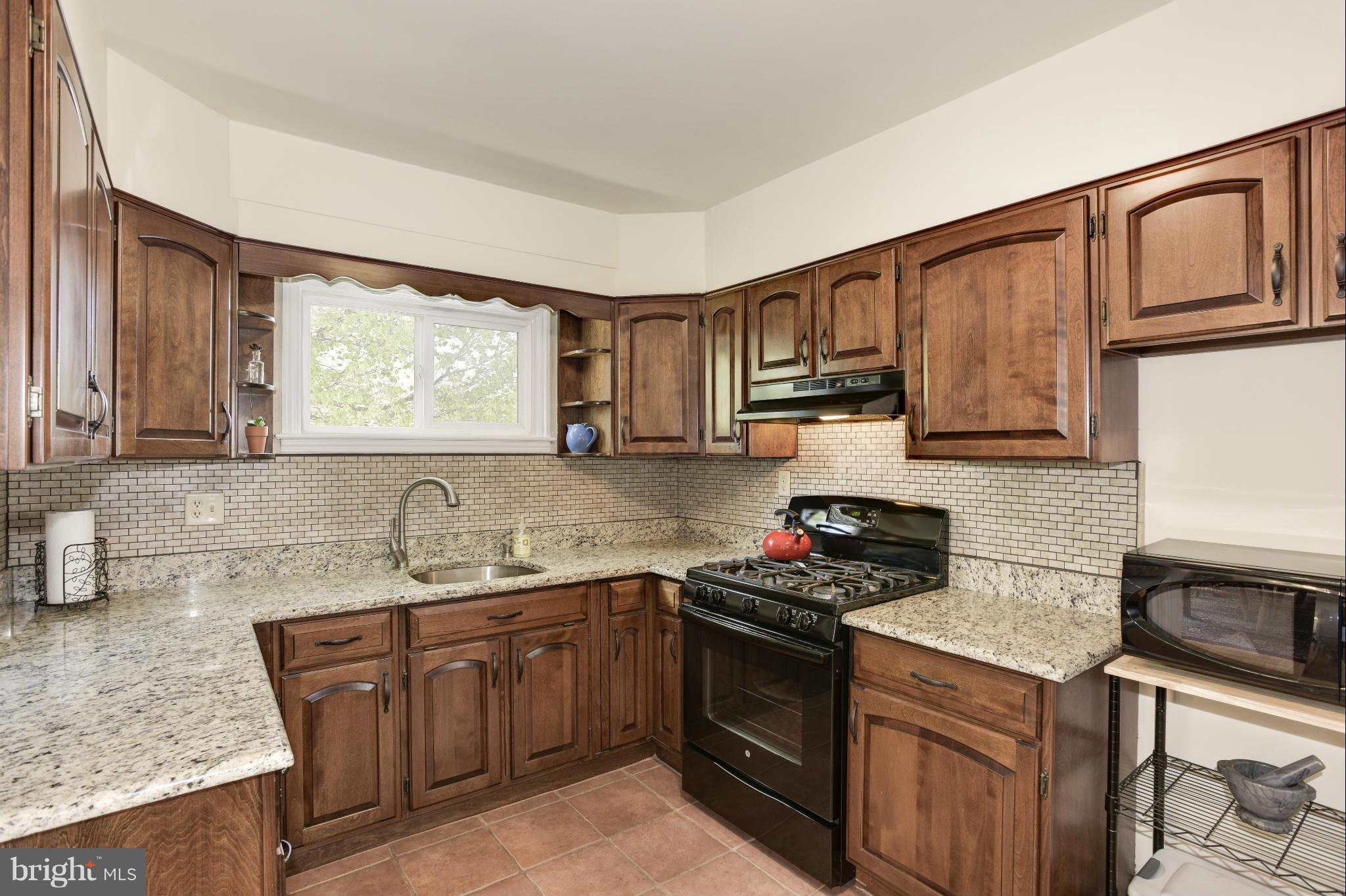 5521 Waterloo Road Ellicott City, MD 21043 - Photo 12 of 30 a kitchen with sink a stove and cabinets