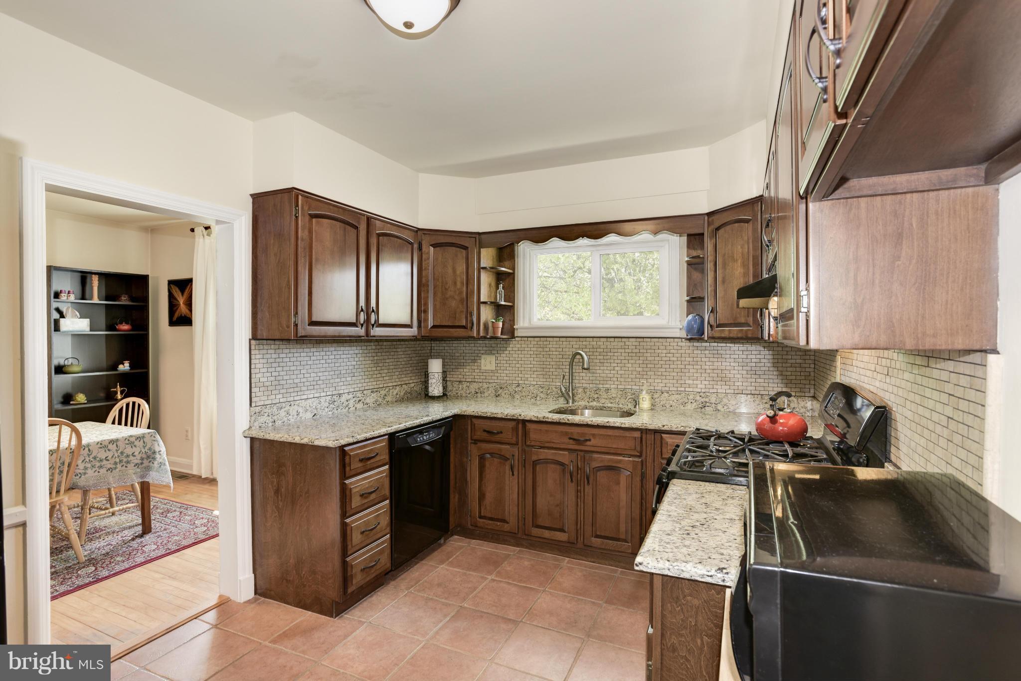 5521 Waterloo Road Ellicott City, MD 21043 - Photo 13 of 30 a kitchen with a sink stove and cabinets