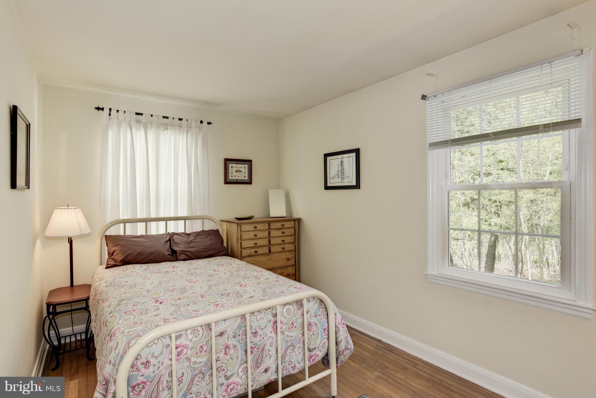 5521 Waterloo Road Ellicott City, MD 21043 - Photo 16 of 30 a bedroom with a bed and a lamp