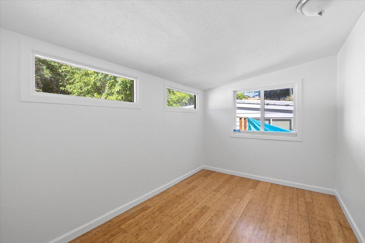939 South Valley View Road, Unit 12 Ashland, OR 97520 - Photo 12 of 19 a view of an empty room with window and wooden floor