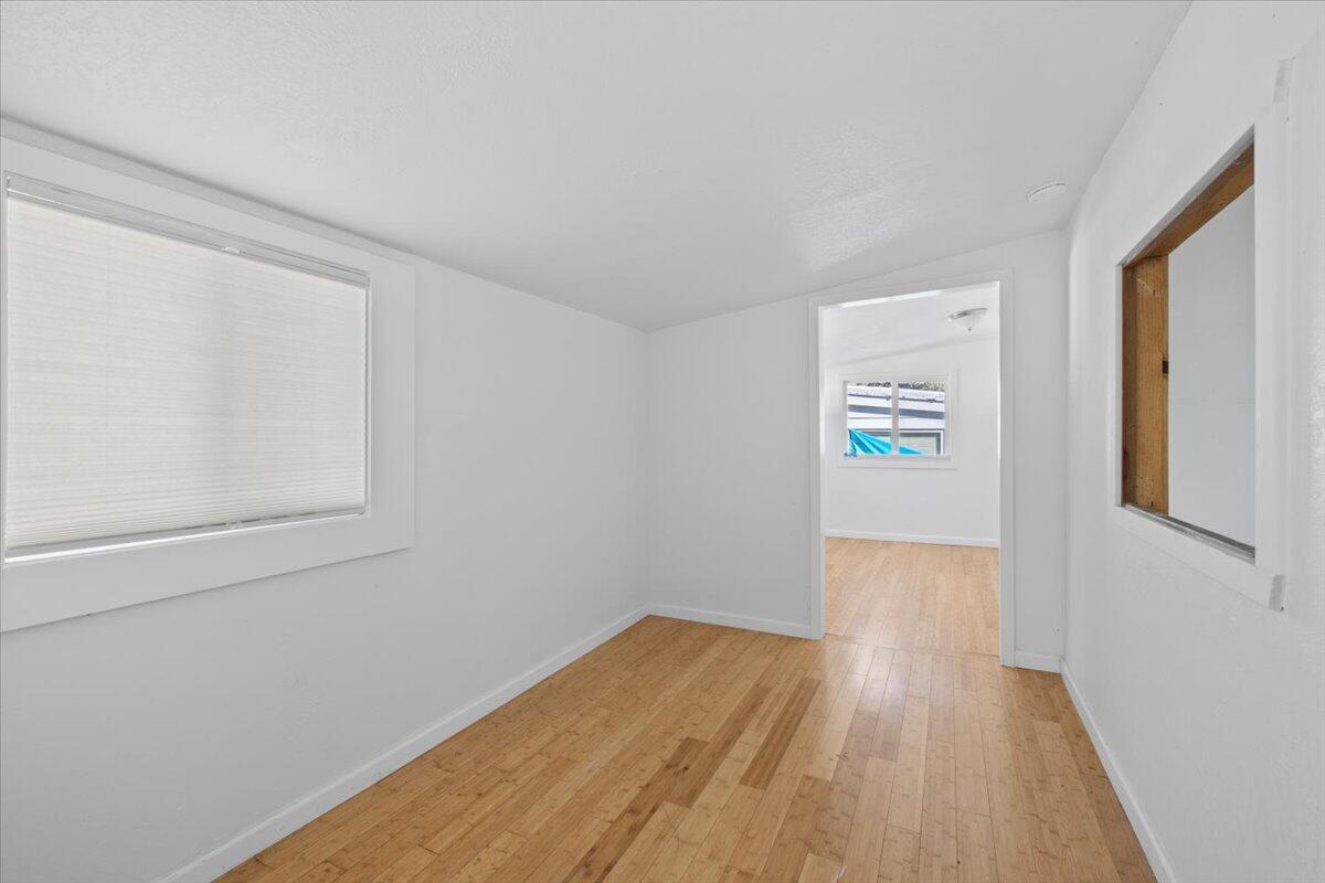 939 South Valley View Road, Unit 12 Ashland, OR 97520 - Photo 13 of 19 a view of an empty room with wooden floor and a window